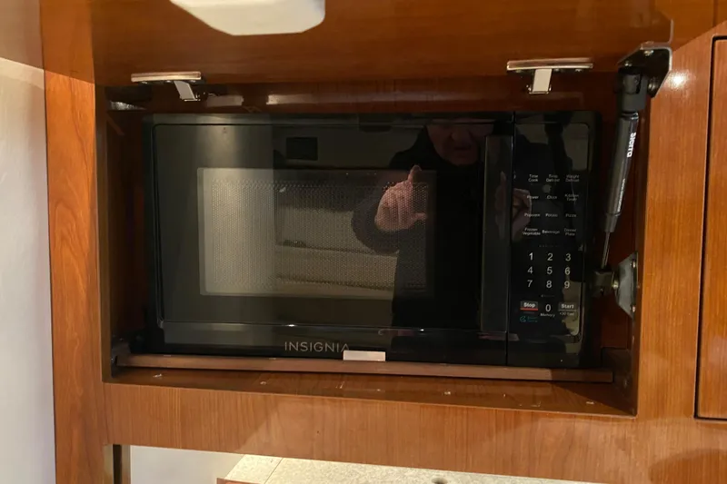 Slide: The Image of Microwave inside 2008 Regal 3360 Window Express boat's wooden cabinet. - 25