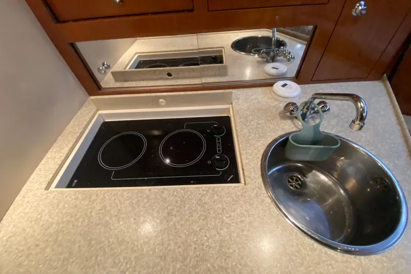 Slide: The Image of 2008 Regal 3360 Window Express yacht kitchen with stove and sink. - 26