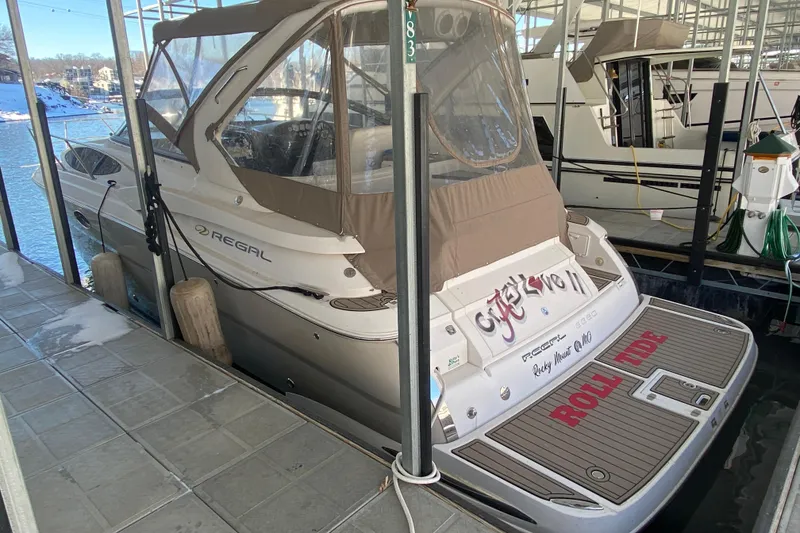 Slide: The Image of 2008 Regal 3360 Window Express boat docked, featuring "Roll Tide" on the deck. - 3