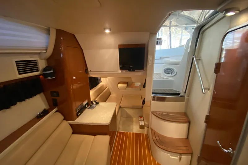 Slide: The Image of 2008 Regal 3360 Window Express interior with seating, table, and TV. - 32