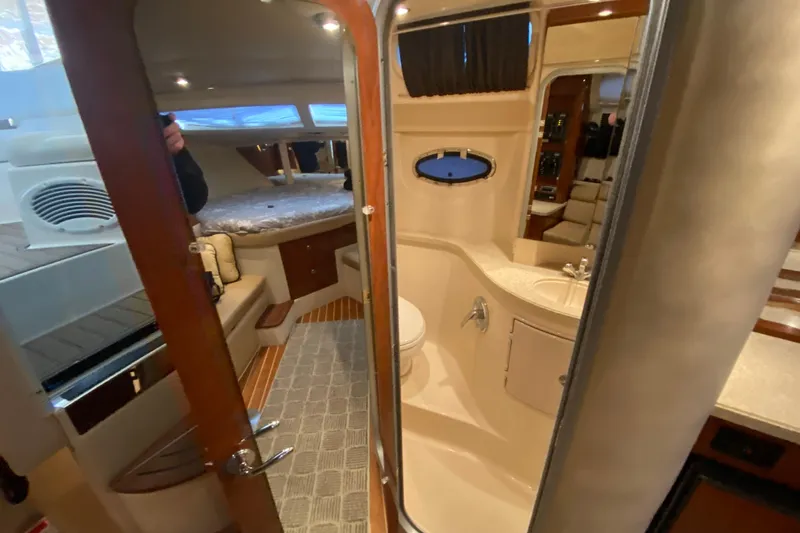 Slide: The Image of Interior of 2008 Regal 3360 Window Express yacht, featuring cozy cabin and bathroom. - 34