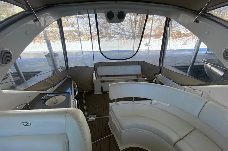 Slide: The Image of Interior of 2008 Regal 3360 Window Express boat with white seating and wood flooring. - 42