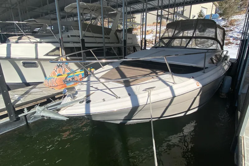 Slide: The Image of 2008 Regal 3360 Window Express boat docked in a marina under a covered structure. - 6