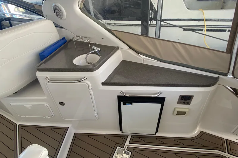 Slide: The Image of 2008 Regal 3360 Window Express boat interior with sink, counter, and mini fridge. - 9