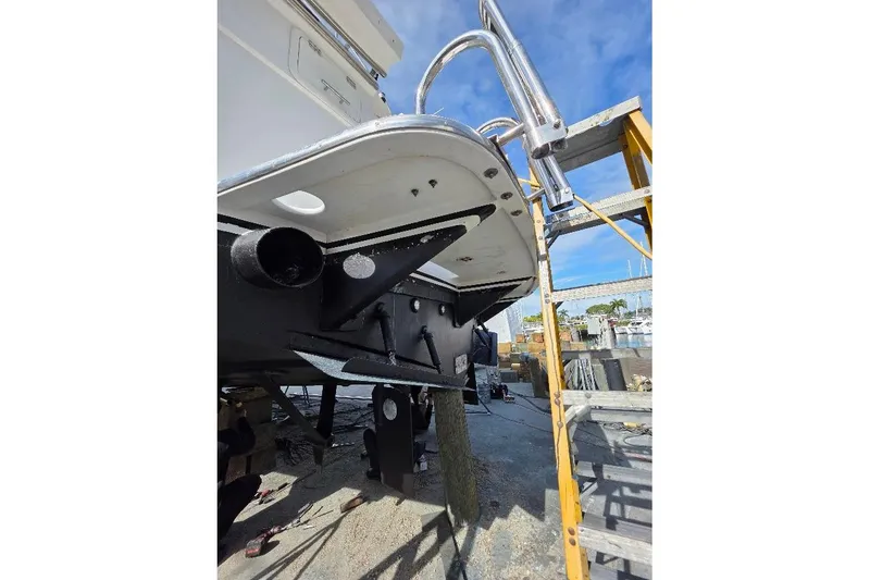 Slide: The Image of 1993 McKinna 48 Pilothouse yacht under maintenance, showing hull and ladder details. - 100