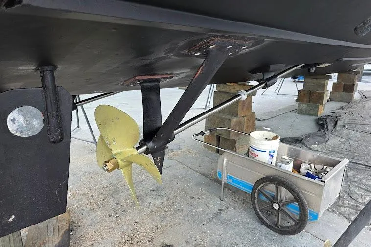 Slide: The Image of 1993 McKinna 48 Pilothouse boat under maintenance, showing propeller and repair tools. - 107