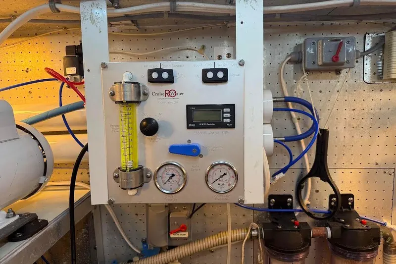 Slide: The Image of Control panel in a 1993 McKinna 48 Pilothouse engine room with gauges and wiring. - 123