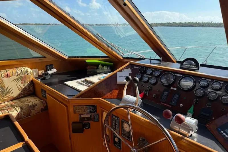 Slide: The Image of 1993 McKinna 48 Pilothouse interior with steering wheel, gauges, and ocean view. - 126