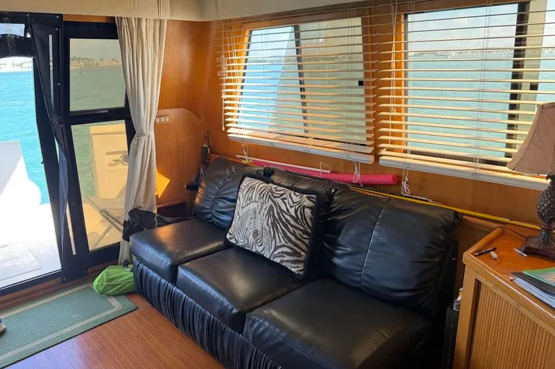 Slide: The Image of Interior of 1993 McKinna 48 Pilothouse with black leather sofa and zebra-print pillow. - 128