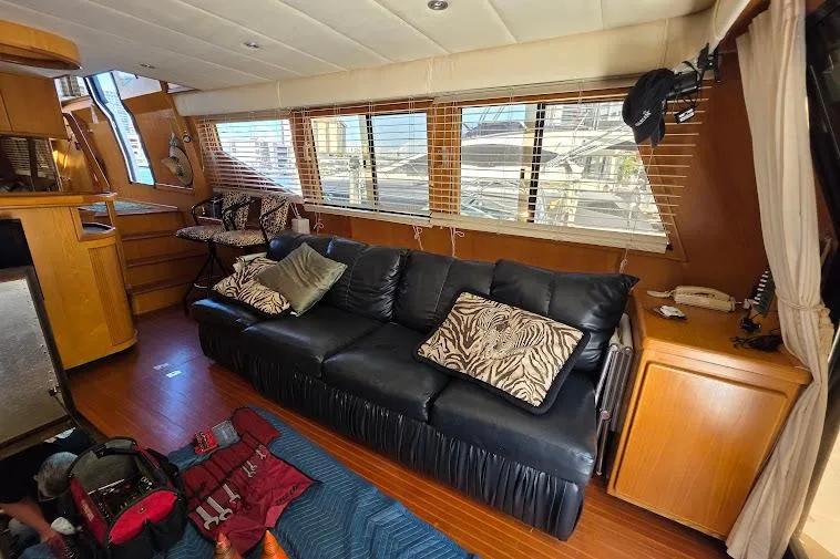 Slide: The Image of Interior of 1993 McKinna 48 Pilothouse with black leather sofa and wooden accents. - 19