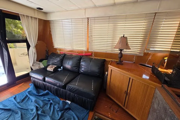 Slide: The Image of Interior of 1993 McKinna 48 Pilothouse with leather sofa, wooden cabinets, and blinds. - 20