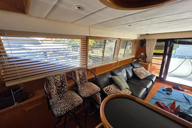Slide: The Image of Interior of 1993 McKinna 48 Pilothouse with leopard print stools and black leather sofa. - 28
