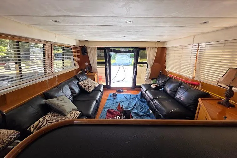 Slide: The Image of Luxurious interior of a 1993 McKinna 48 Pilothouse yacht with leather seating and large windows. - 32