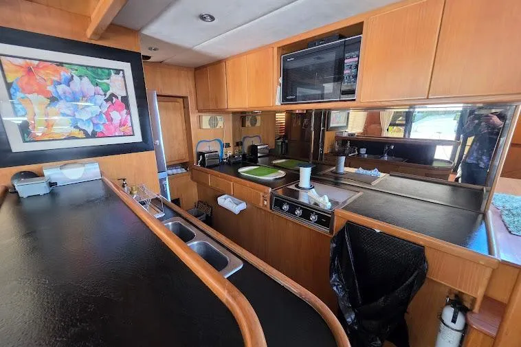 Slide: The Image of Interior of 1993 McKinna 48 Pilothouse yacht with modern kitchen and colorful artwork. - 34