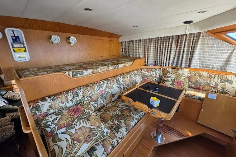 Slide: The Image of Interior of 1993 McKinna 48 Pilothouse with floral upholstery and wooden accents. - 36