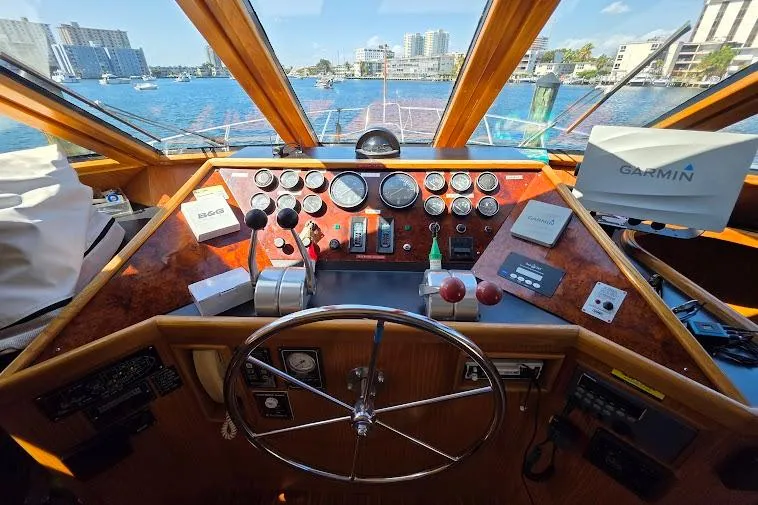 Slide: The Image of Pilothouse of 1993 McKinna 48 with navigation equipment and scenic waterfront view. - 38