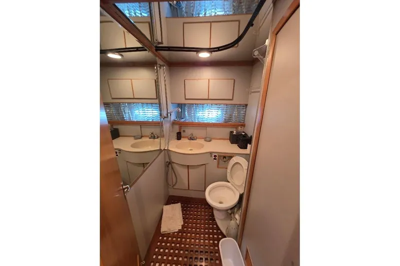 Slide: The Image of Bathroom interior of 1993 McKinna 48 Pilothouse yacht, featuring dual sinks and toilet. - 49
