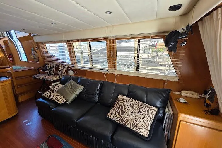 Slide: The Image of Luxurious interior of a 1993 McKinna 48 Pilothouse yacht with leather seating and zebra-patterned cushions. - 60
