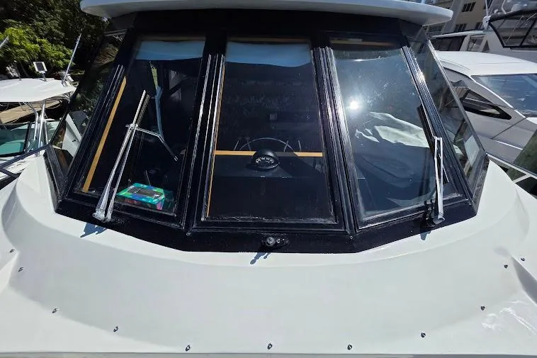 Slide: The Image of 1993 McKinna 48 Pilothouse boat with front windshield and wipers in a marina setting. - 68