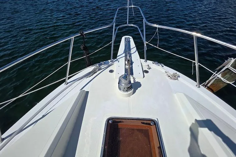 Slide: The Image of Bow view of 1993 McKinna 48 Pilothouse yacht on water. - 69