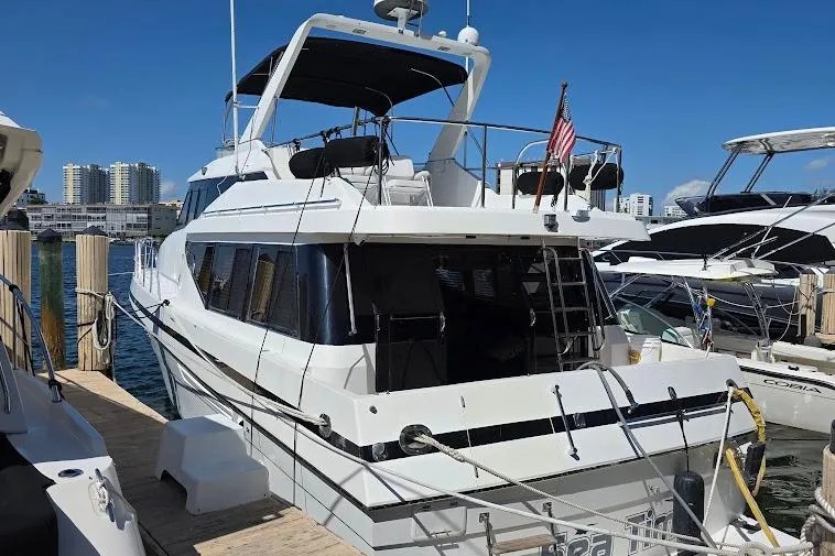 Slide: The Image of 1993 McKinna 48 Pilothouse yacht docked at marina under clear blue sky. - 7