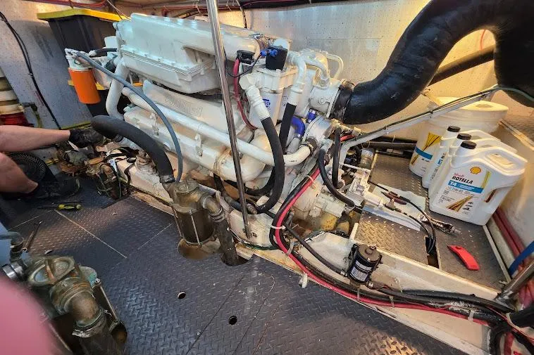 Slide: The Image of Engine room of a 1993 McKinna 48 Pilothouse with visible machinery and maintenance tools. - 73