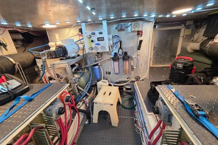 Slide: The Image of Engine room of a 1993 McKinna 48 Pilothouse with equipment and wiring. - 74