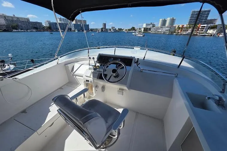 Slide: The Image of 1993 McKinna 48 Pilothouse helm with waterfront cityscape view. - 79