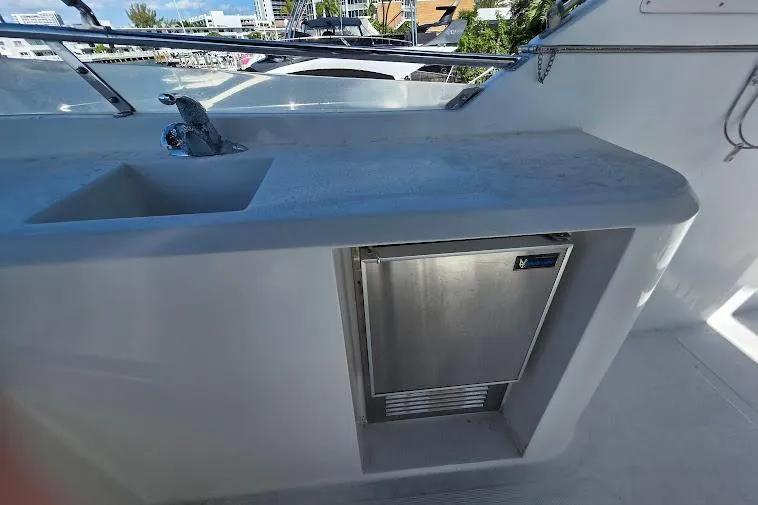 Slide: The Image of 1993 McKinna 48 Pilothouse yacht with sink and mini fridge on deck. - 93