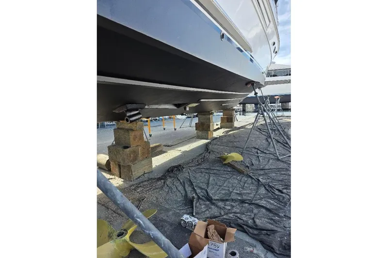 Slide: The Image of 1993 McKinna 48 Pilothouse yacht on blocks, undergoing maintenance in a shipyard. - 97