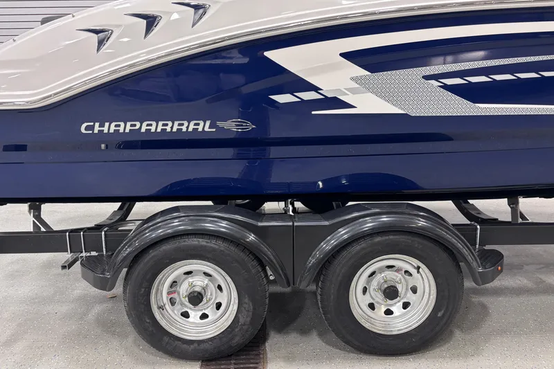 Slide: The Image of 2026 Chaparral 21 SSi boat on trailer, featuring sleek blue and white design. - 12