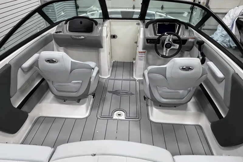 Slide: The Image of Interior of 2026 Chaparral 21 SSi boat with modern seating and steering console. - 21