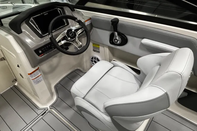 Slide: The Image of 2026 Chaparral 21 SSi boat interior with steering wheel and captain's seat. - 23