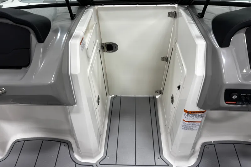 Slide: The Image of 2026 Chaparral 21 SSi boat interior with gray flooring and storage compartments. - 31