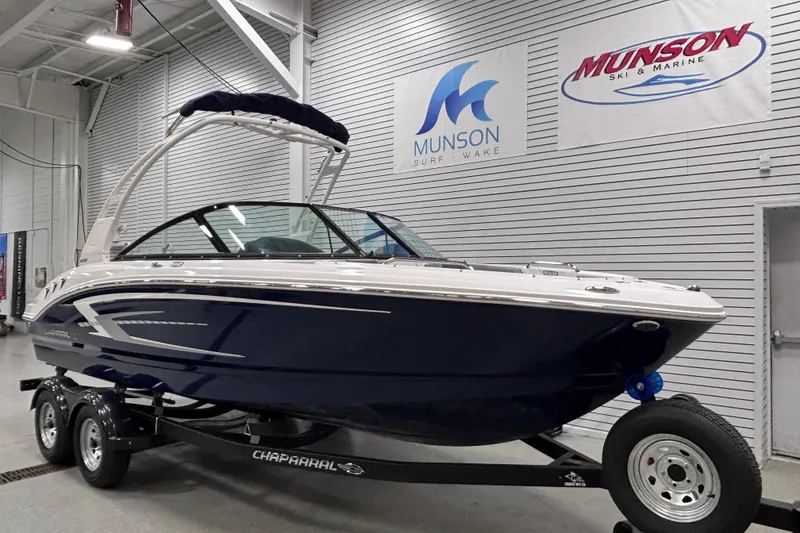 Slide: The Image of 2026 Chaparral 21 SSi boat on trailer in showroom, Munson Ski & Marine signage. - 4
