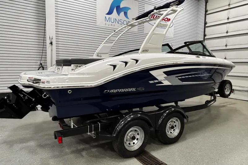Slide: The Image of 2026 Chaparral 21 SSi boat on trailer in showroom, side view. - 2