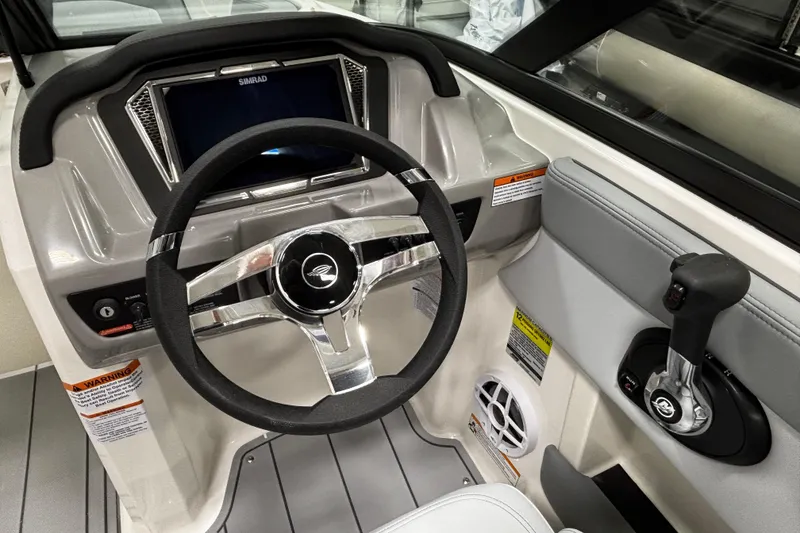 Slide: The Image of 2026 Chaparral 21 SSi boat dashboard with steering wheel and control panel. - 22