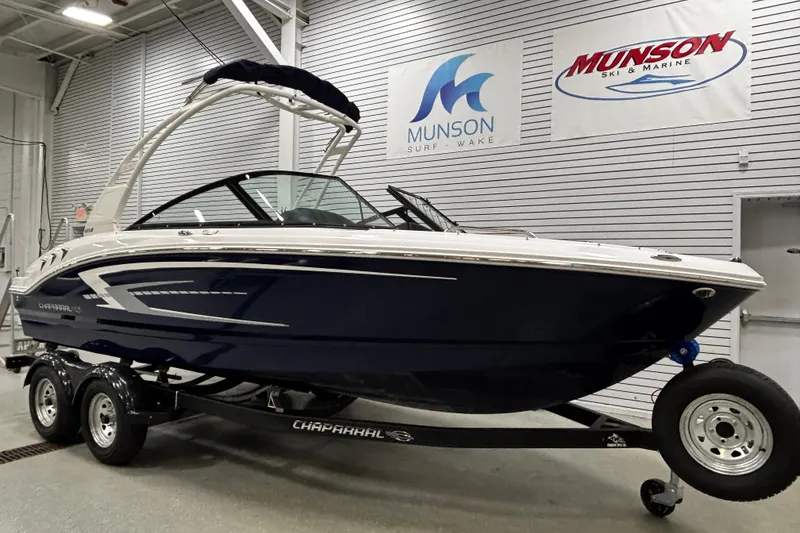 Slide: The Image of 2026 Chaparral 21 SSi boat on trailer in showroom, Munson Ski & Marine signage. - 3