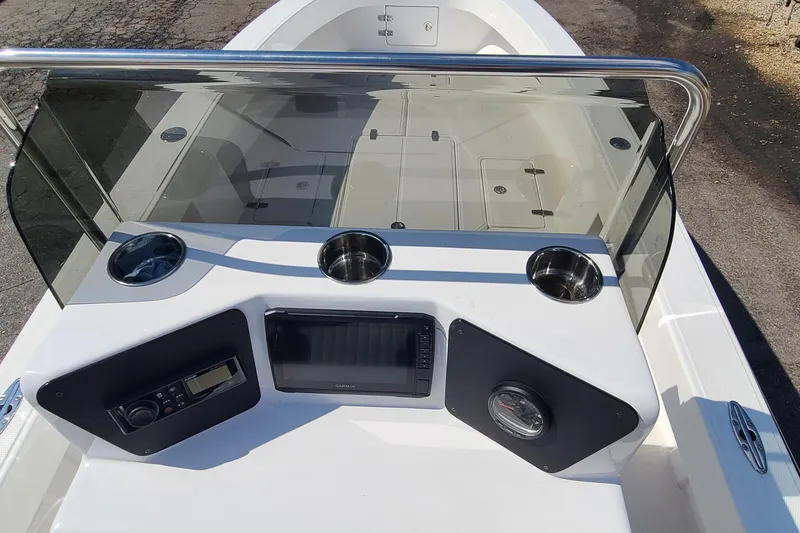 Slide: The Image of 2025 Paramount 21 boat dashboard with navigation system and cup holders. - 18
