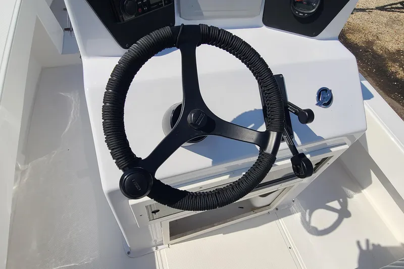Slide: The Image of Steering wheel of a 2025 Paramount 21 boat, featuring modern controls and sleek design. - 19
