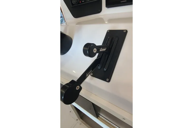 Slide: The Image of Control lever on a 2025 Paramount 21 boat dashboard. - 20