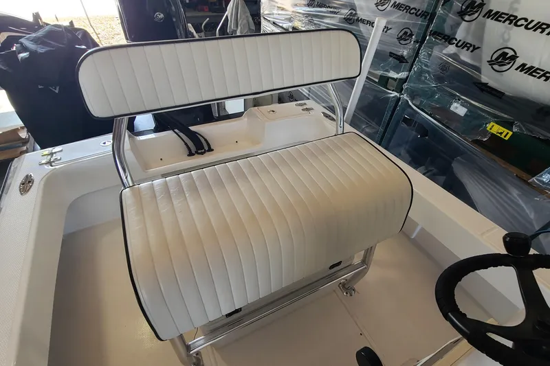 Slide: The Image of White cushioned seating on 2025 Paramount 21 boat, featuring sleek design and Mercury branding. - 22