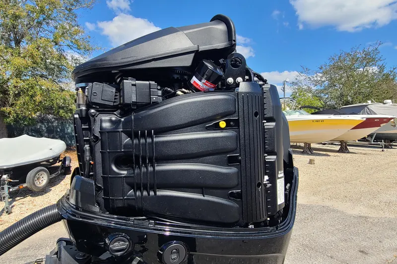 Slide: The Image of Outboard motor of a 2025 Paramount 21 boat, detailed view under blue sky. - 24