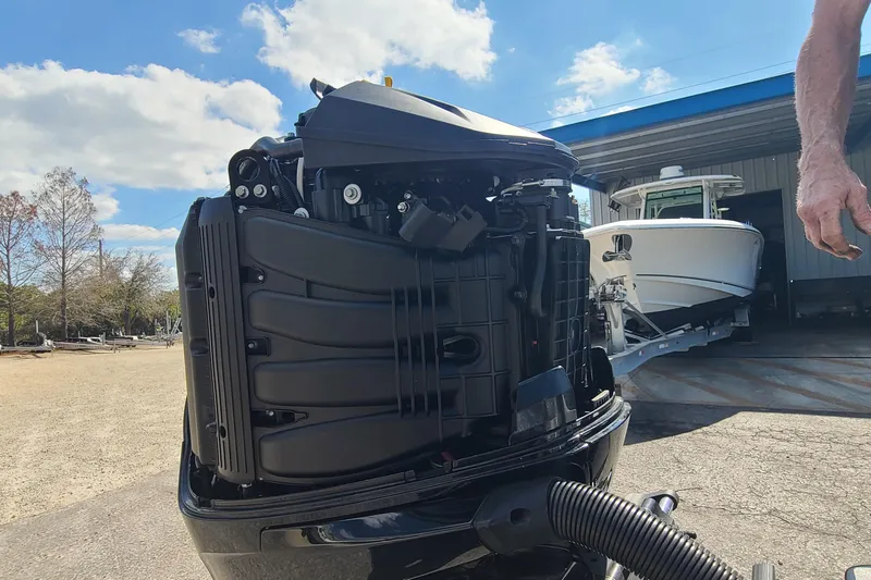 Slide: The Image of 2025 Paramount 21 boat engine close-up with a boat in the background under a blue sky. - 25