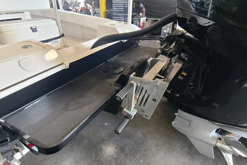 Slide: The Image of 2025 Paramount 21 boat engine and transom detail in a workshop setting. - 28