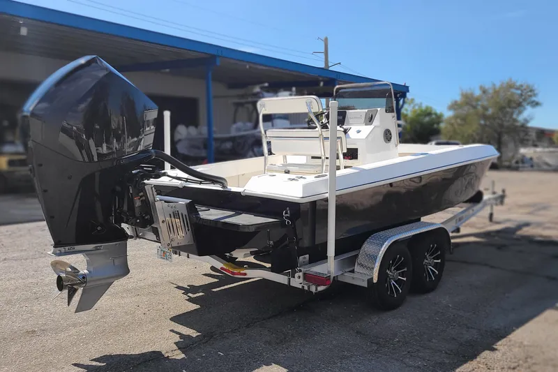 Slide: The Image of 2025 Paramount 21 boat on trailer, featuring a powerful outboard motor. - 5