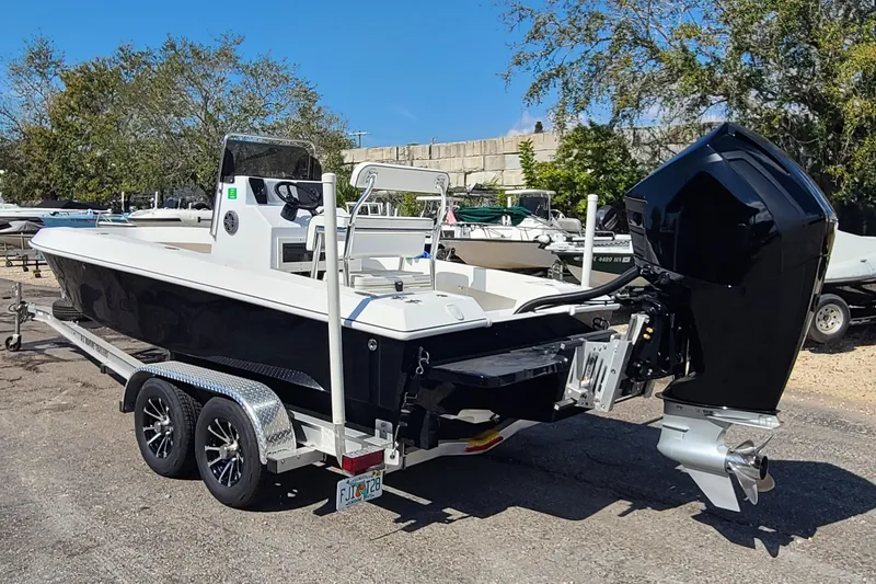 Slide: The Image of 2025 Paramount 21 boat on trailer, featuring sleek design and powerful outboard motor. - 6
