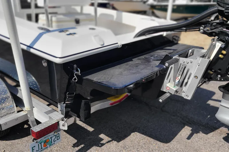 Slide: The Image of 2025 Paramount 21 boat on trailer with motor mount, Florida license plate visible. - 7