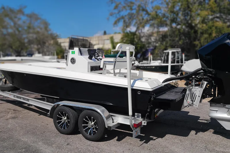 Slide: The Image of 2025 Paramount 21 boat on trailer, sleek design, parked outdoors, ready for adventure. - 8
