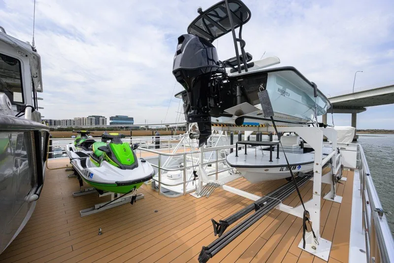 Slide: The Image of Deck of 2011 C & G Boatworks Explorer with jet skis and small boat. - 11